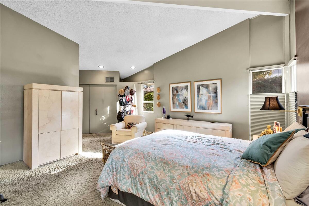 37800 Da Vall Drive, Unit 1 Rancho Mirage, CA 92270 - Photo 18 of 36 a bedroom with a bed and wooden floor