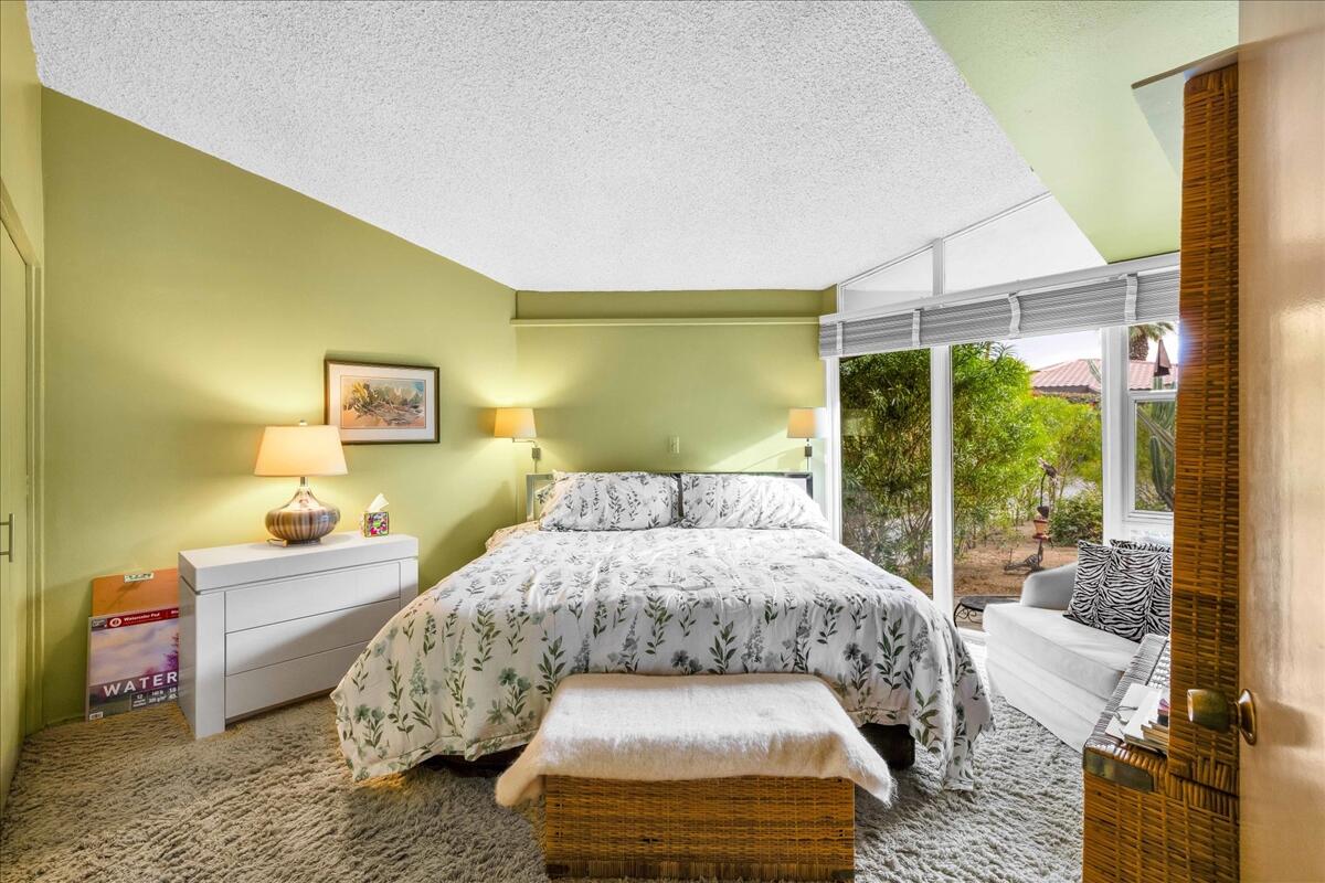 37800 Da Vall Drive, Unit 1 Rancho Mirage, CA 92270 - Photo 21 of 36 a bedroom with a bed and large window