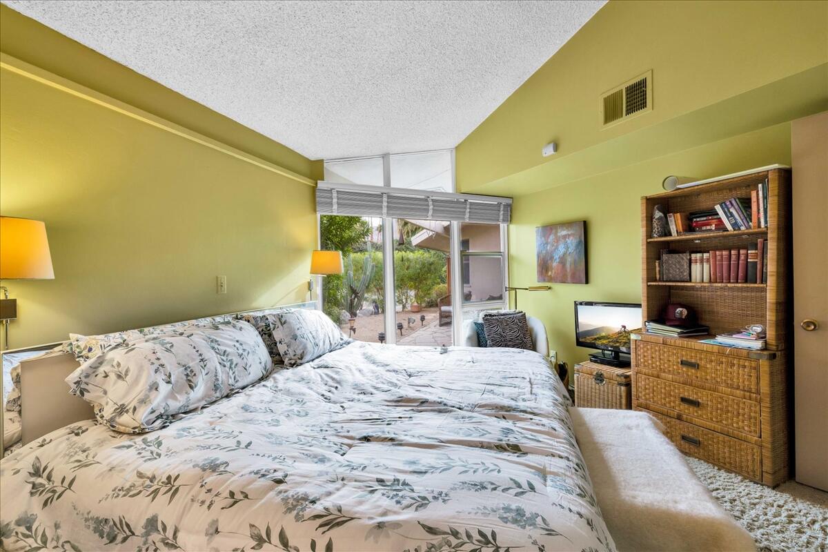 37800 Da Vall Drive, Unit 1 Rancho Mirage, CA 92270 - Photo 22 of 36 a bedroom with a large bed and a window
