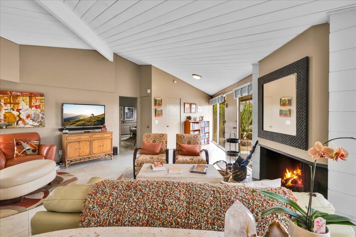 37800 Da Vall Drive, Unit 1 Rancho Mirage, CA 92270 - Photo 6 of 36 a living room with furniture and a flat screen tv