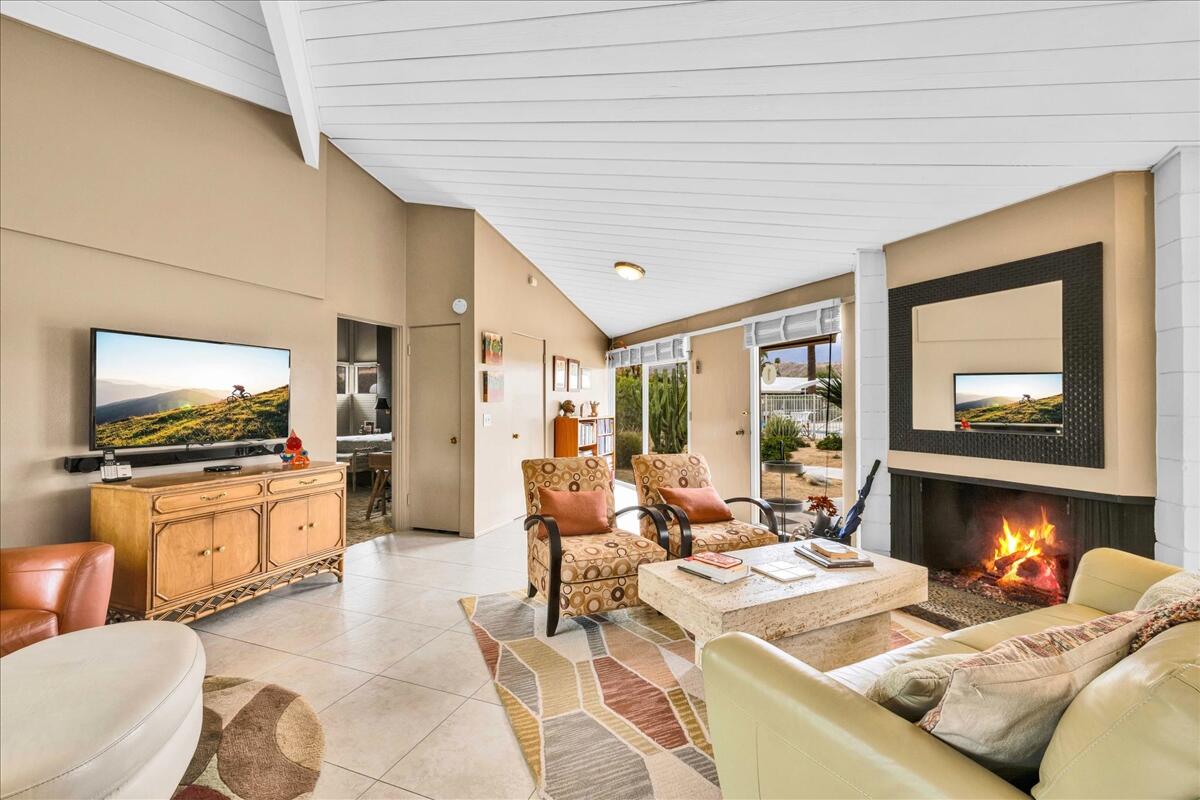 37800 Da Vall Drive, Unit 1 Rancho Mirage, CA 92270 - Photo 7 of 36 a living room with fireplace furniture and a flat screen tv