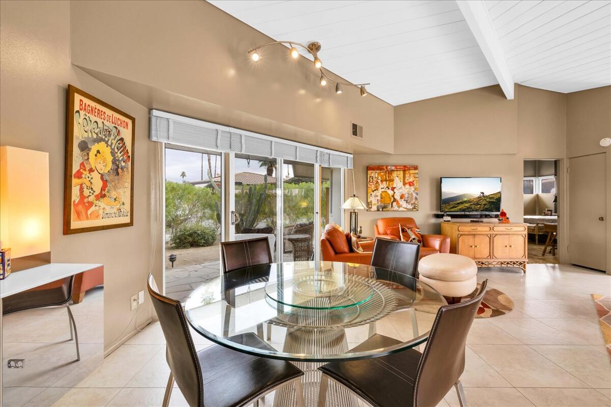 37800 Da Vall Drive, Unit 1 Rancho Mirage, CA 92270 - Photo 10 of 36 a dining room with furniture a large window and kitchen view