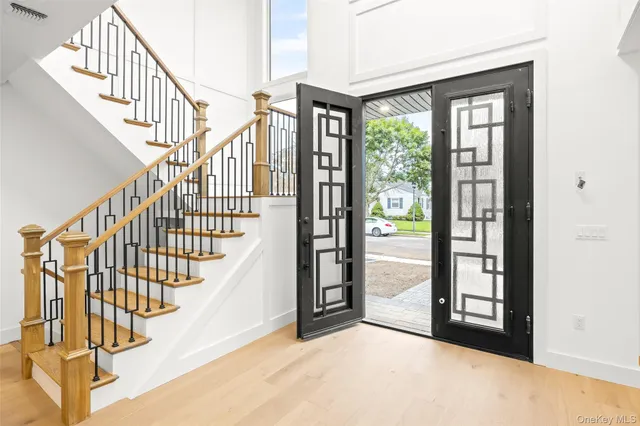 a kitchen with stainless steel appliances granite countertop a stove a sink dishwasher a refrigerator and a oven with wooden floor