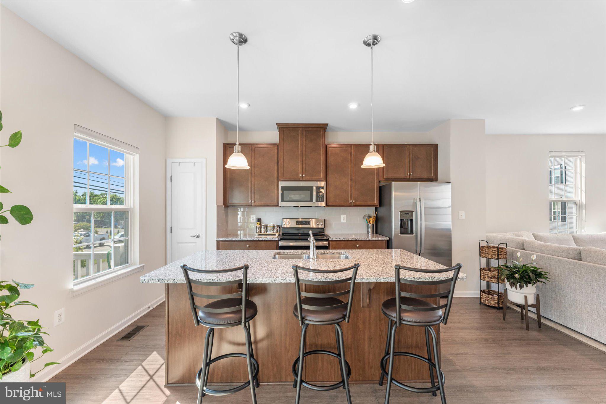 1776 Scenic Loop Culpeper, VA 22701 - Photo 7 of 36 a kitchen with stainless steel appliances a dining table chairs stove refrigerator and cabinets