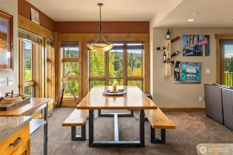 a dining room with furniture a chandelier and window