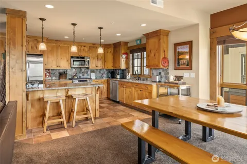 a large kitchen with a table and chairs