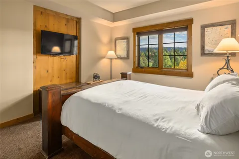 a bedroom with a bed and a flat screen tv