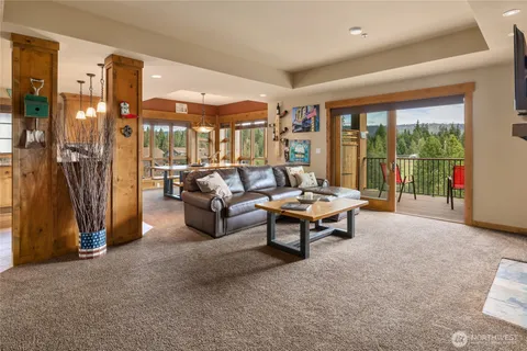 a living room with furniture and a floor to ceiling window