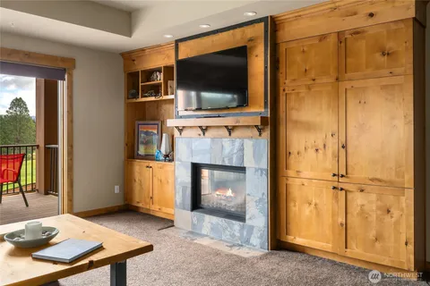 a living room with fireplace furniture and a flat screen tv