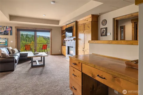 a living room with furniture and large windows