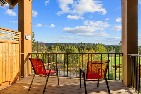 a view of a balcony with chair and table