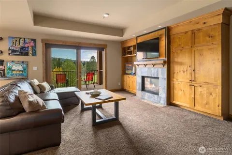 a living room with furniture a large window and a flat screen tv
