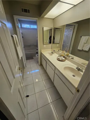a bathroom with a sink mirror and shower