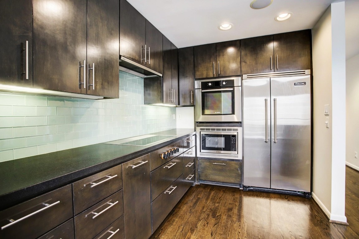 1417 Harold Street, Unit B Houston, TX 77006 - Photo 11 of 28 Sleek kitchen cabinets highlight modern appeal along with Viking refrigerator, Bosch ovens, and Gaggenau cooktop.