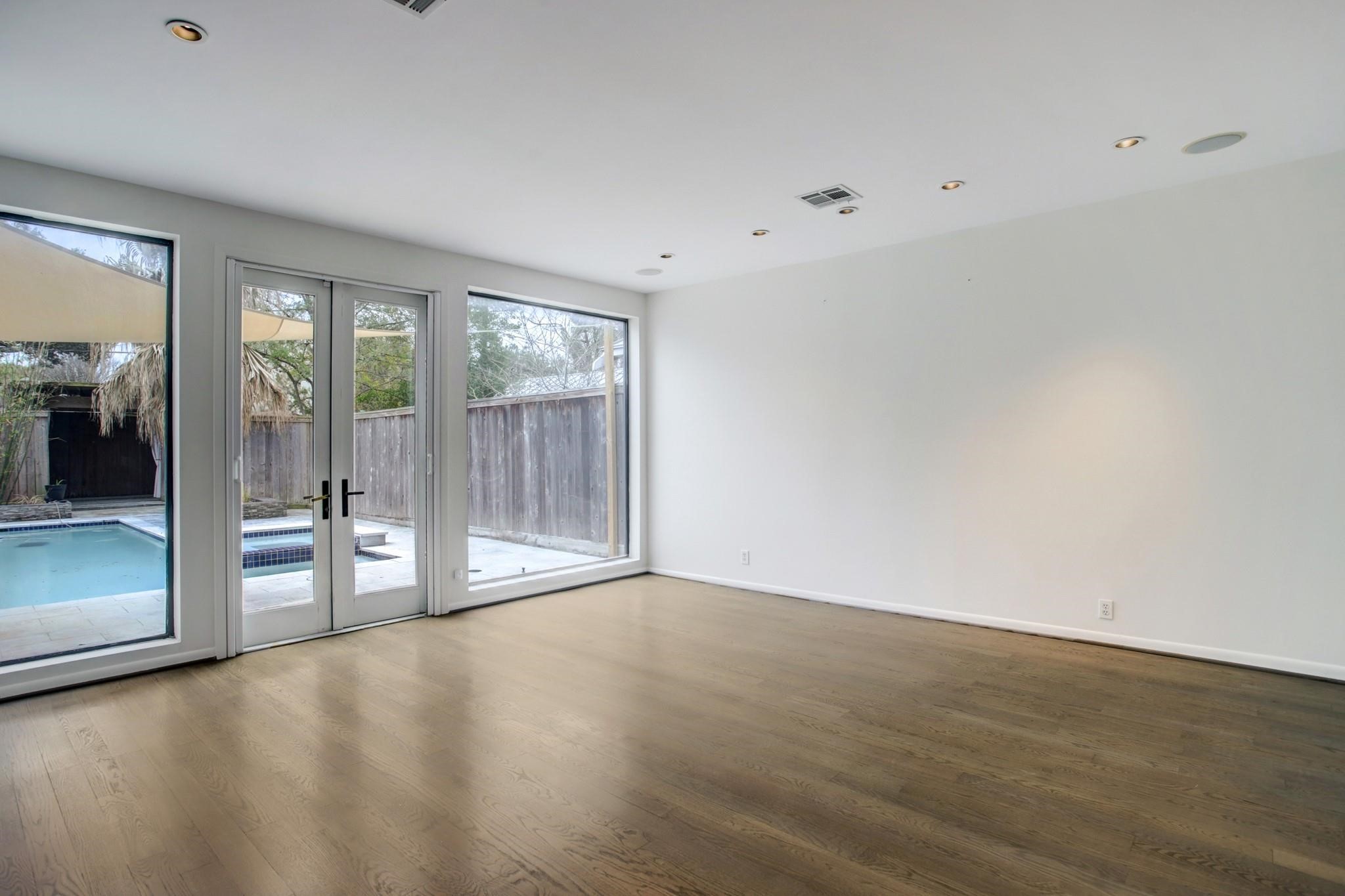 1417 Harold Street, Unit B Houston, TX 77006 - Photo 8 of 28 Another view of the living room with wall to wall French doors and windows.