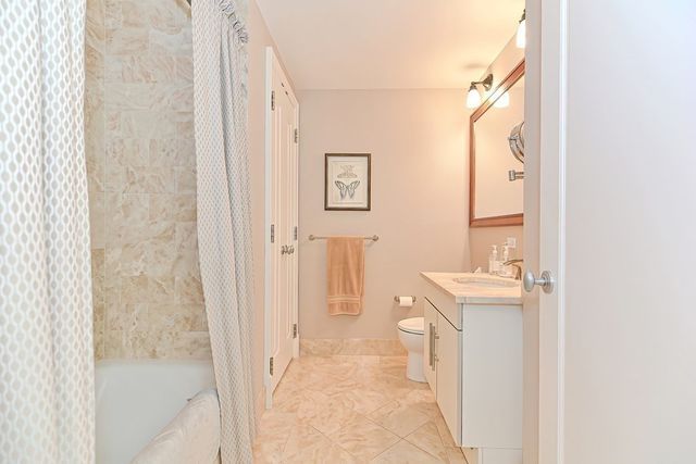 a bathroom with a tub sink and mirror
