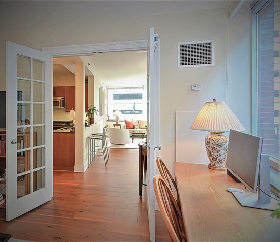 a view of living room with furniture and wooden floor