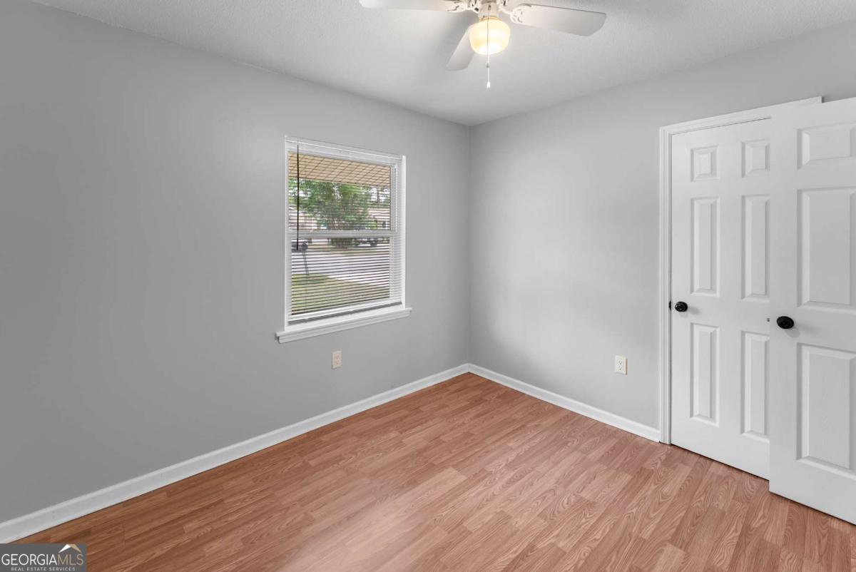 320 West Whatley Street Pooler, GA 31322 - Photo 11 of 34 wooden floor in an empty room with a window