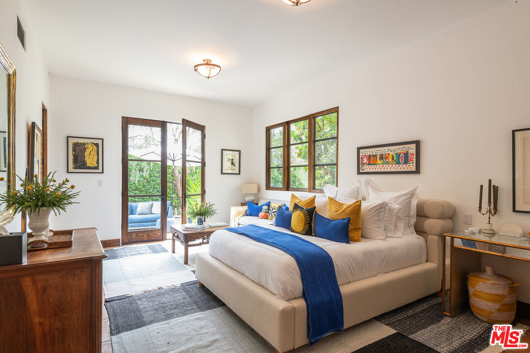 1101 Cold Canyon Road Calabasas, CA 91302 - Photo 32 of 60 a bedroom with a large bed and a couch