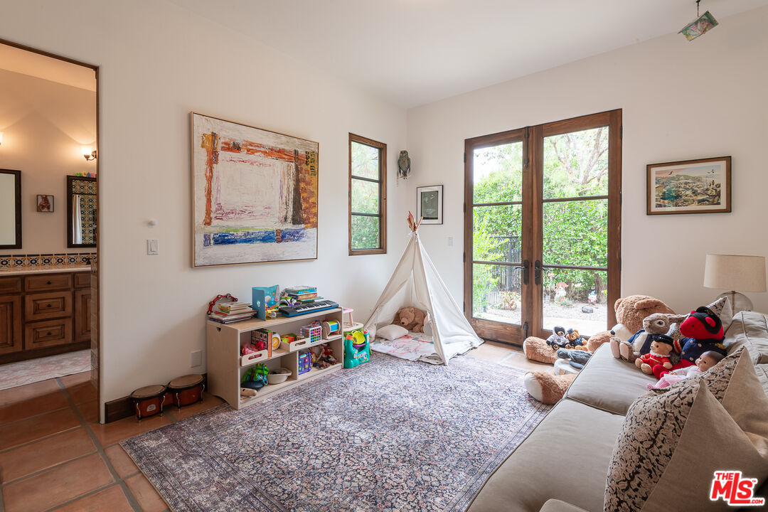 1101 Cold Canyon Road Calabasas, CA 91302 - Photo 34 of 60 a living room with furniture and a floor to ceiling window