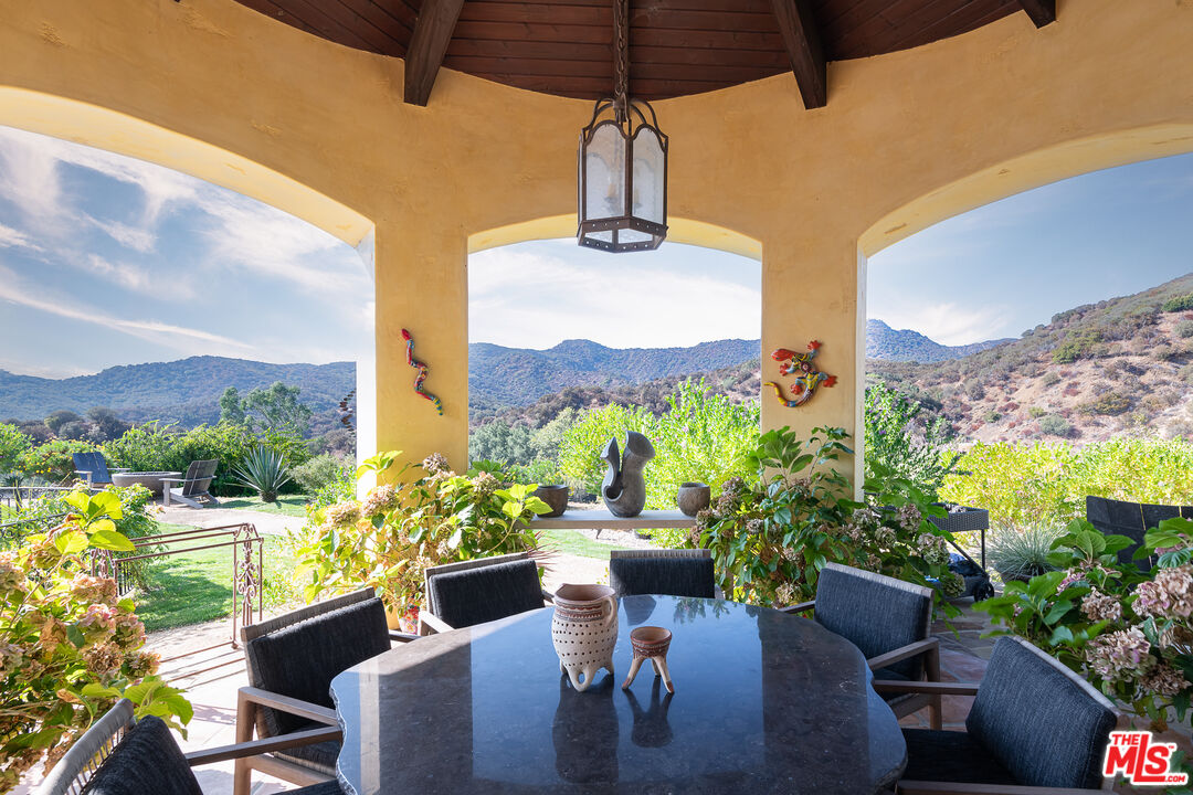 1101 Cold Canyon Road Calabasas, CA 91302 - Photo 36 of 60 a view of a chairs and table in patio with a potted plant