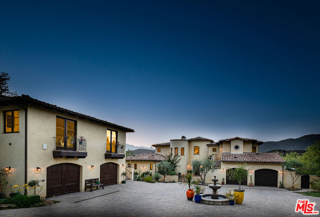 1101 Cold Canyon Road Calabasas, CA 91302 - Photo 5 of 60 a car parked in front of house