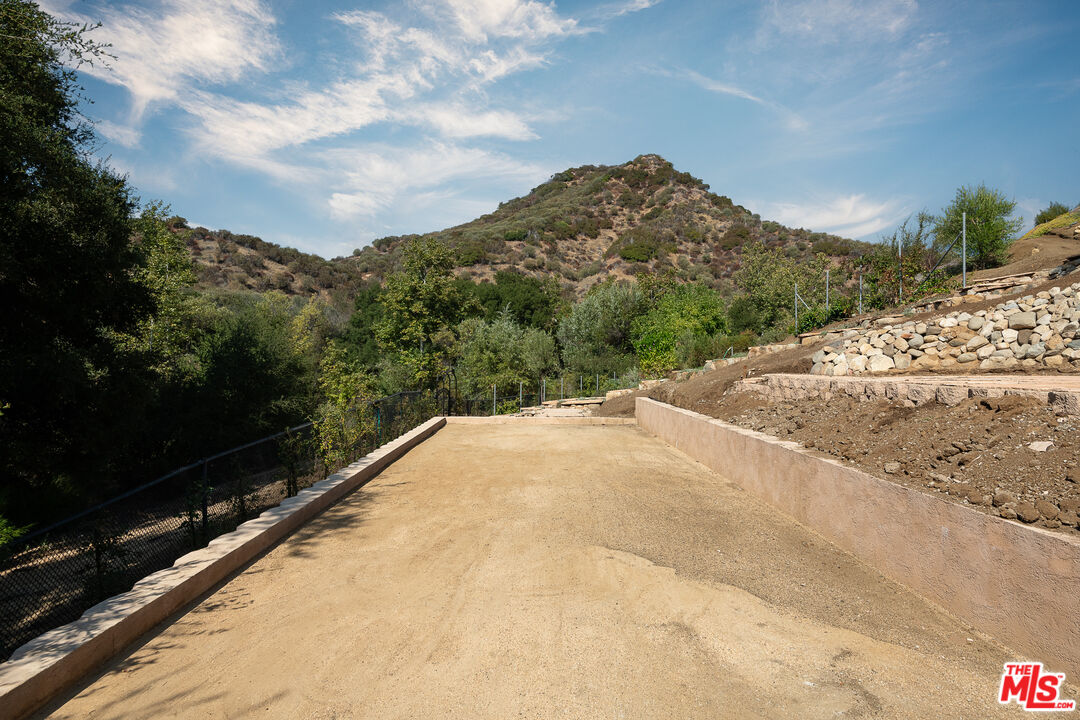 1101 Cold Canyon Road Calabasas, CA 91302 - Photo 53 of 60 a view of a road with a yard