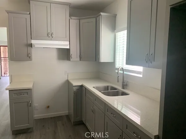 a kitchen with a sink and cabinets