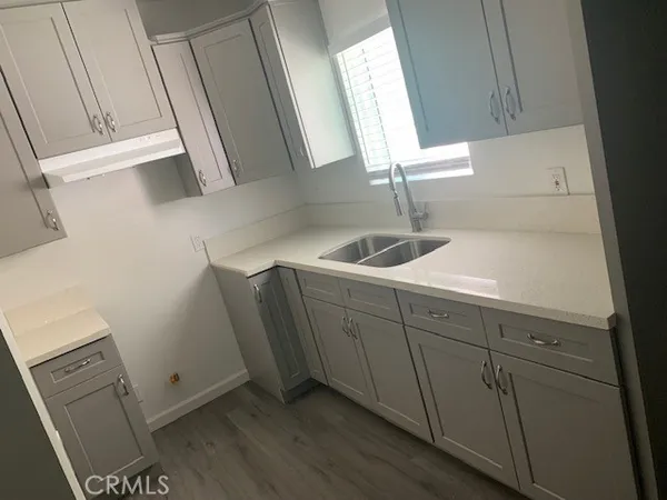 a kitchen with a sink and cabinets