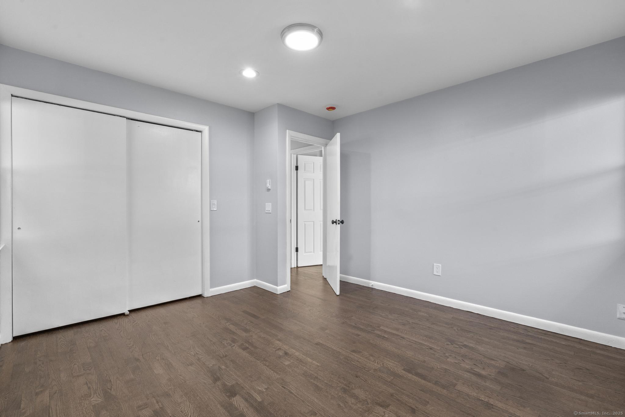 99 Roosevelt Avenue West Haven, CT 06516 - Photo 11 of 27 a view of an empty room with wooden floor