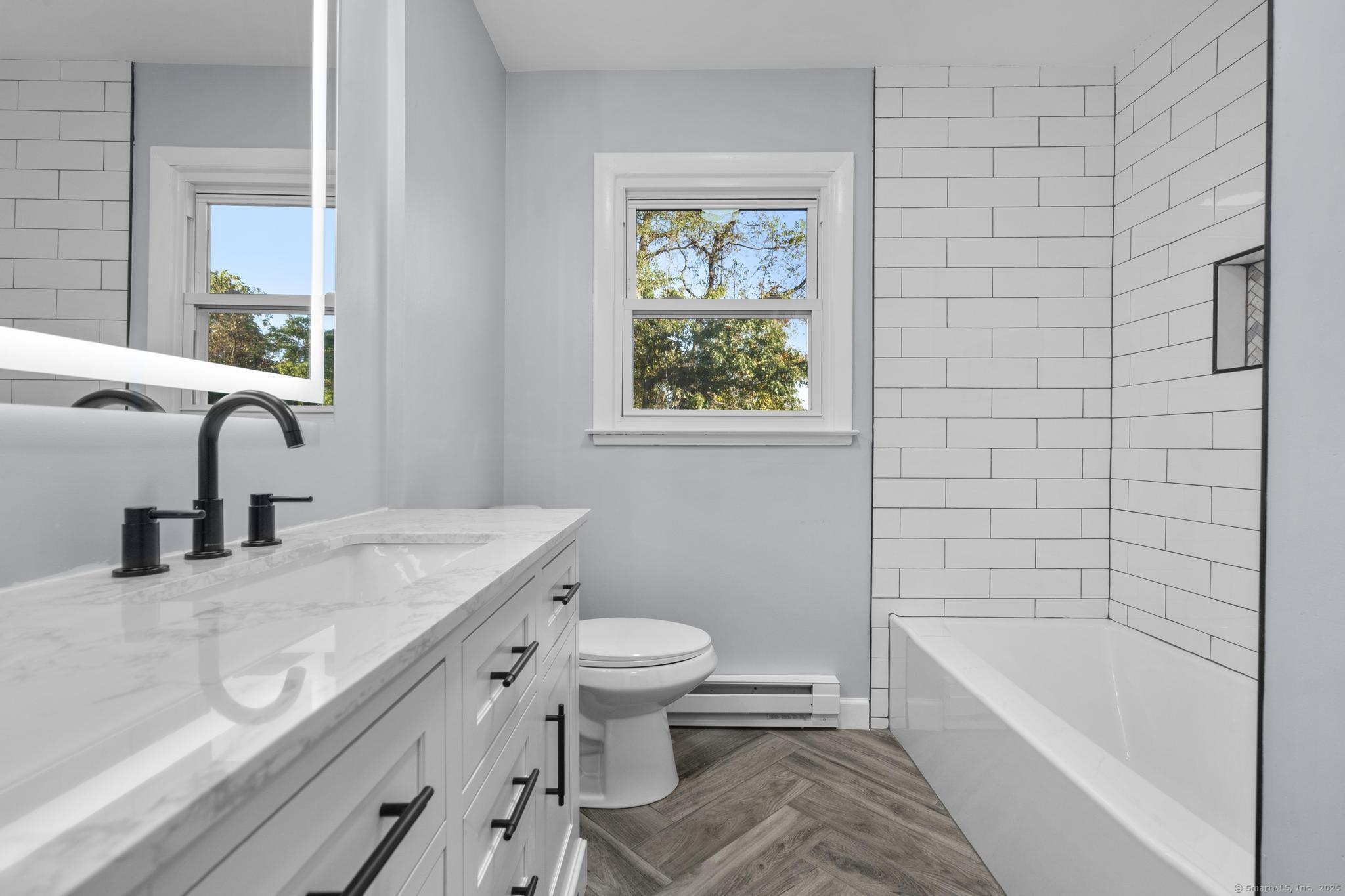 99 Roosevelt Avenue West Haven, CT 06516 - Photo 13 of 27 a bathroom with a granite countertop sink a toilet and bathtub
