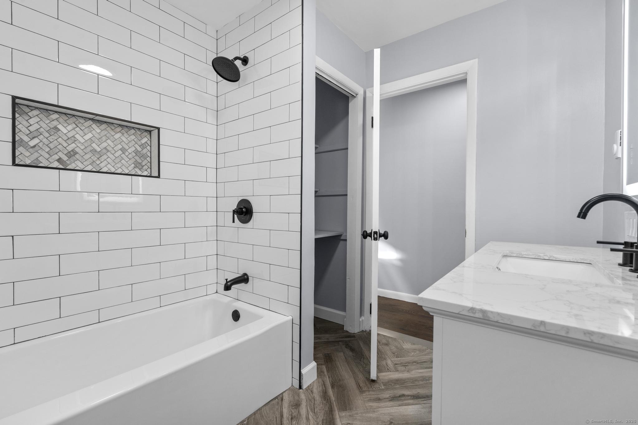 99 Roosevelt Avenue West Haven, CT 06516 - Photo 14 of 27 a bathroom with a granite countertop sink a toilet and shower