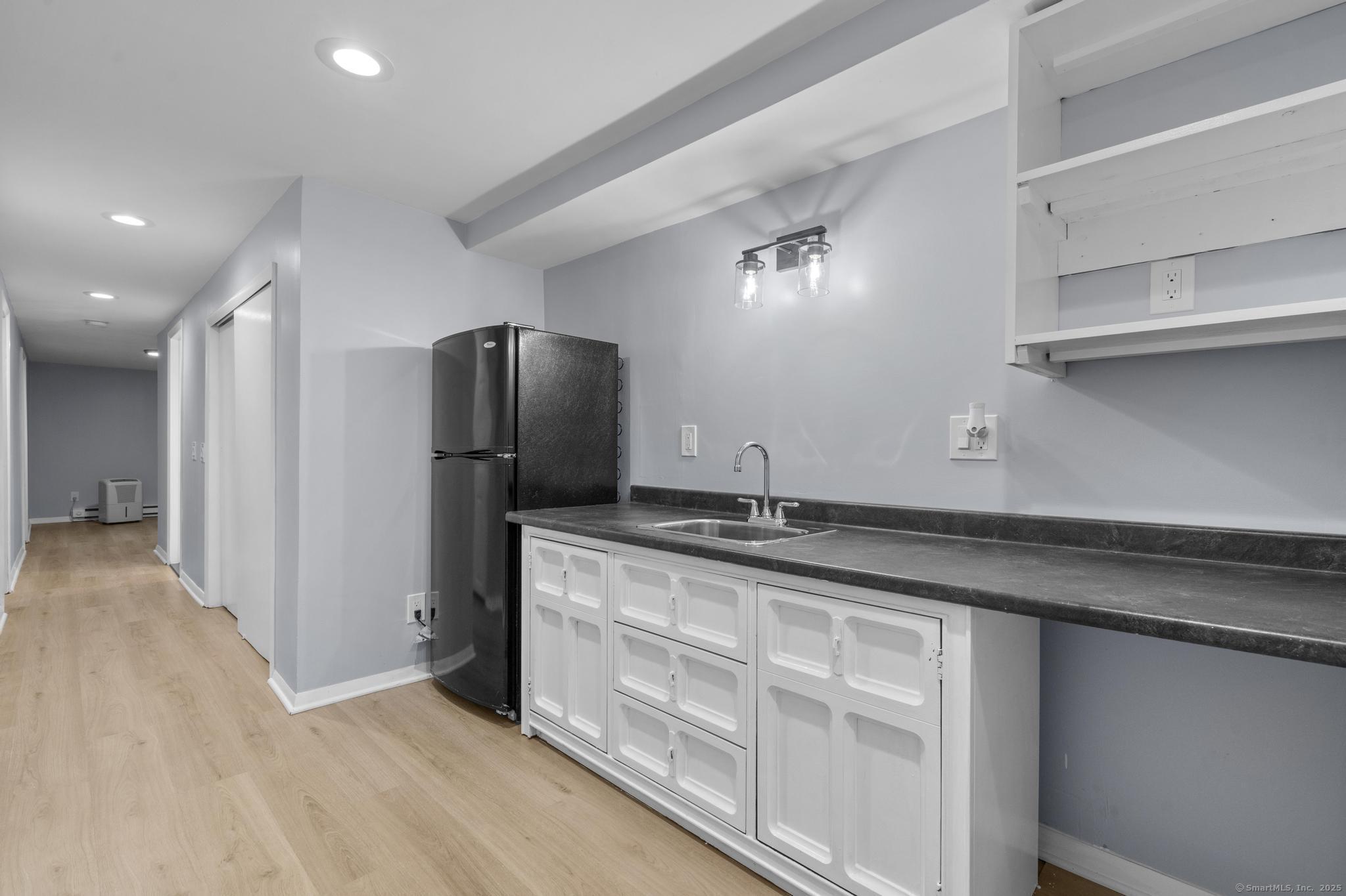 99 Roosevelt Avenue West Haven, CT 06516 - Photo 16 of 27 a kitchen with granite countertop a refrigerator and a sink
