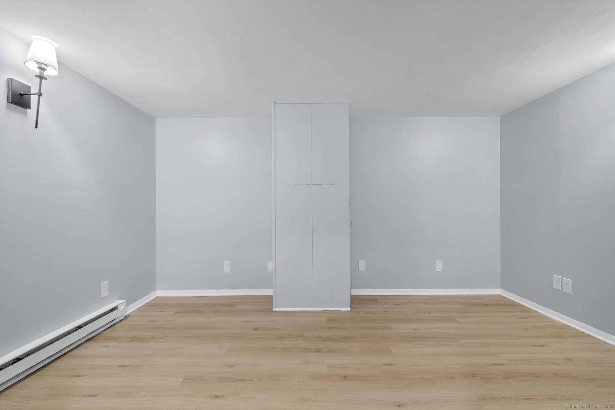 99 Roosevelt Avenue West Haven, CT 06516 - Photo 18 of 27 a view of an empty room with wooden floor