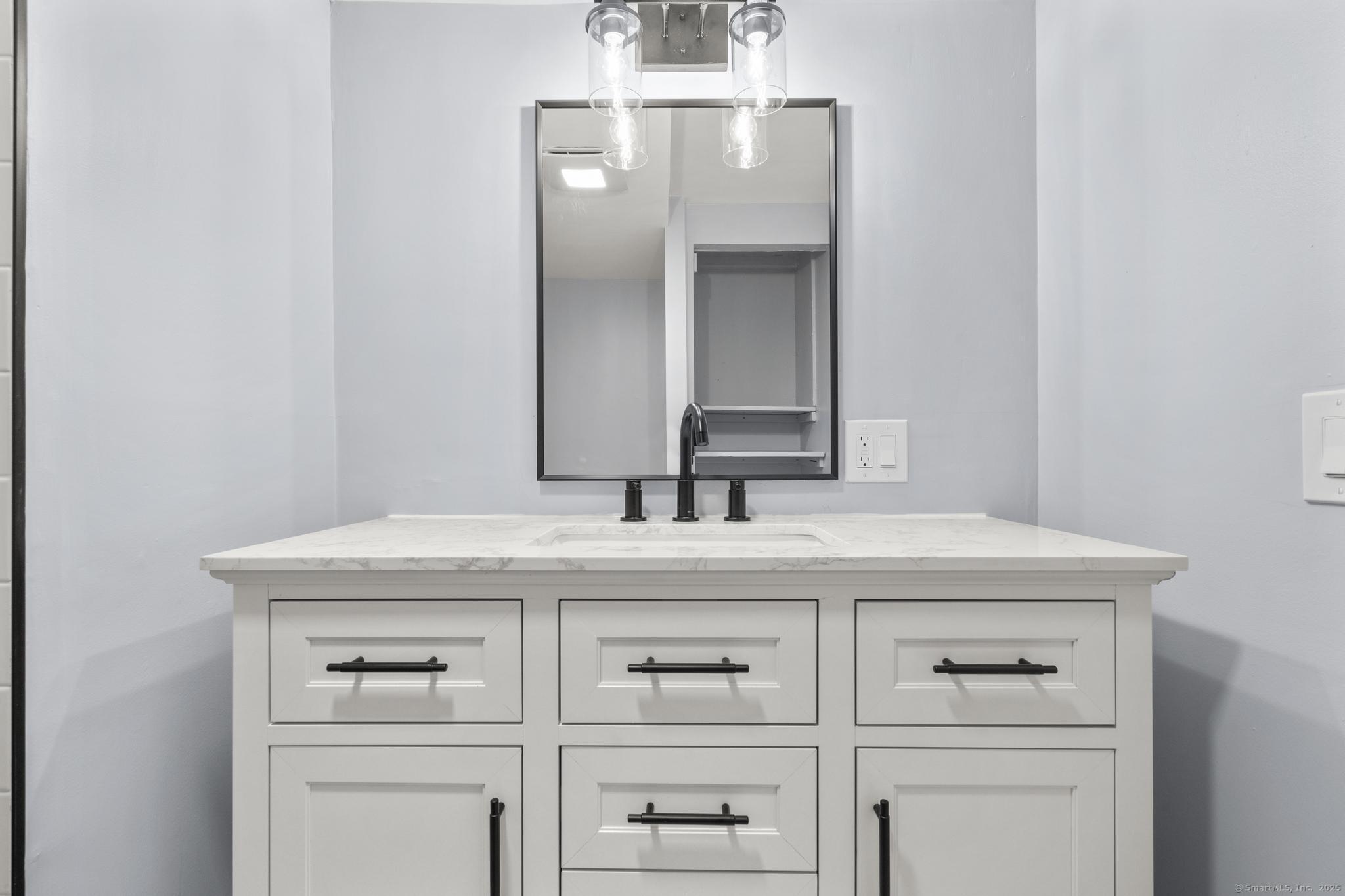 99 Roosevelt Avenue West Haven, CT 06516 - Photo 20 of 27 a bathroom with a sink and a mirror