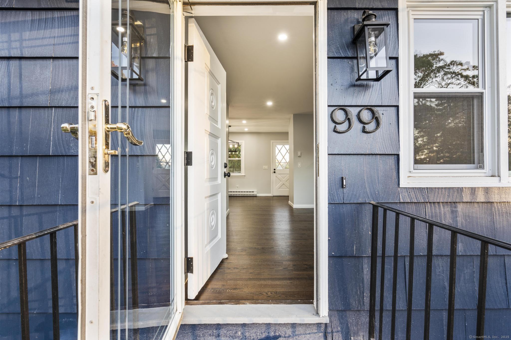 99 Roosevelt Avenue West Haven, CT 06516 - Photo 2 of 27 a view of a hallway with wooden door and stairs