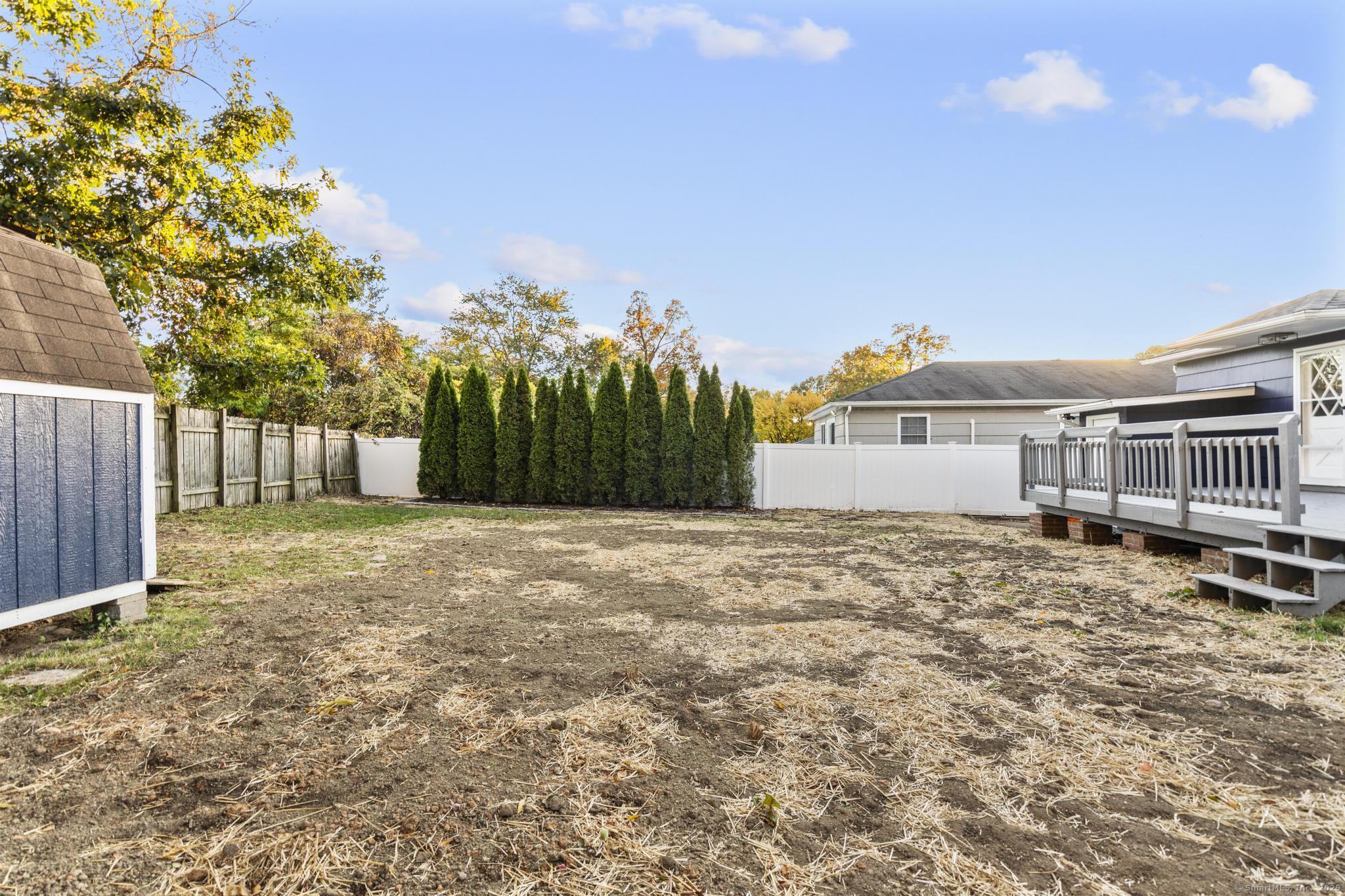99 Roosevelt Avenue West Haven, CT 06516 - Photo 25 of 27 a front view of a house with a yard and garage