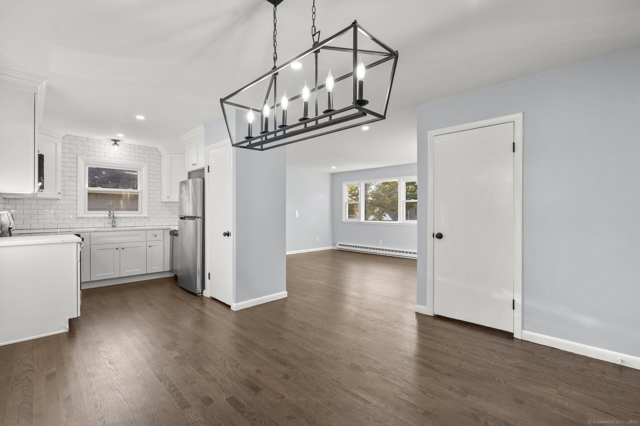 99 Roosevelt Avenue West Haven, CT 06516 - Photo 5 of 27 a view of a kitchen with a sink stainless steel appliances and cabinets