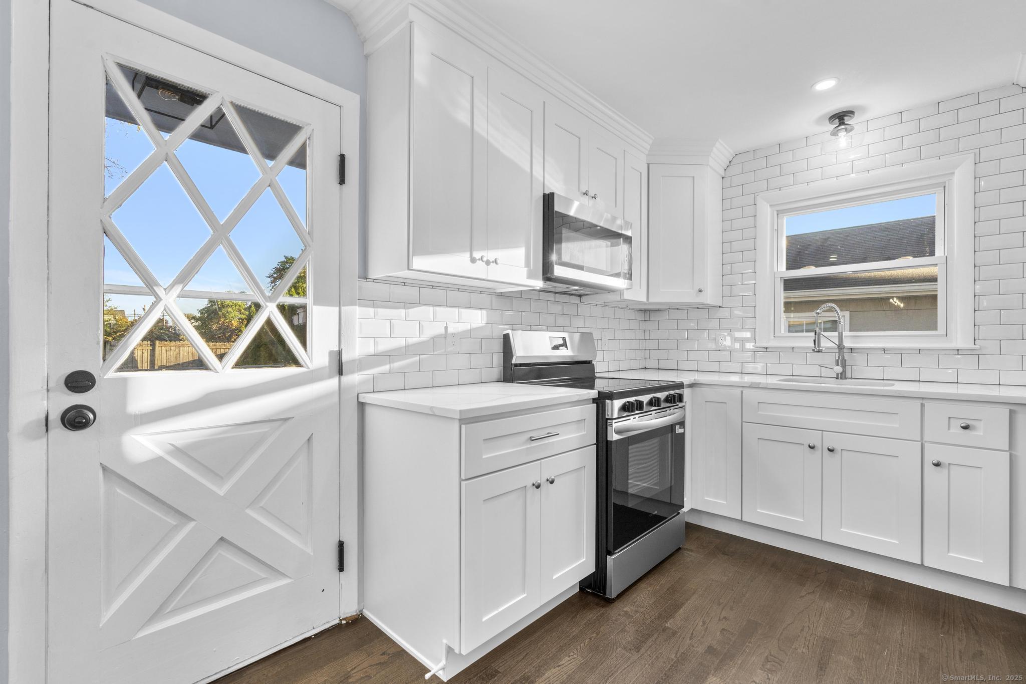 99 Roosevelt Avenue West Haven, CT 06516 - Photo 7 of 27 a kitchen with appliances cabinets and a sink