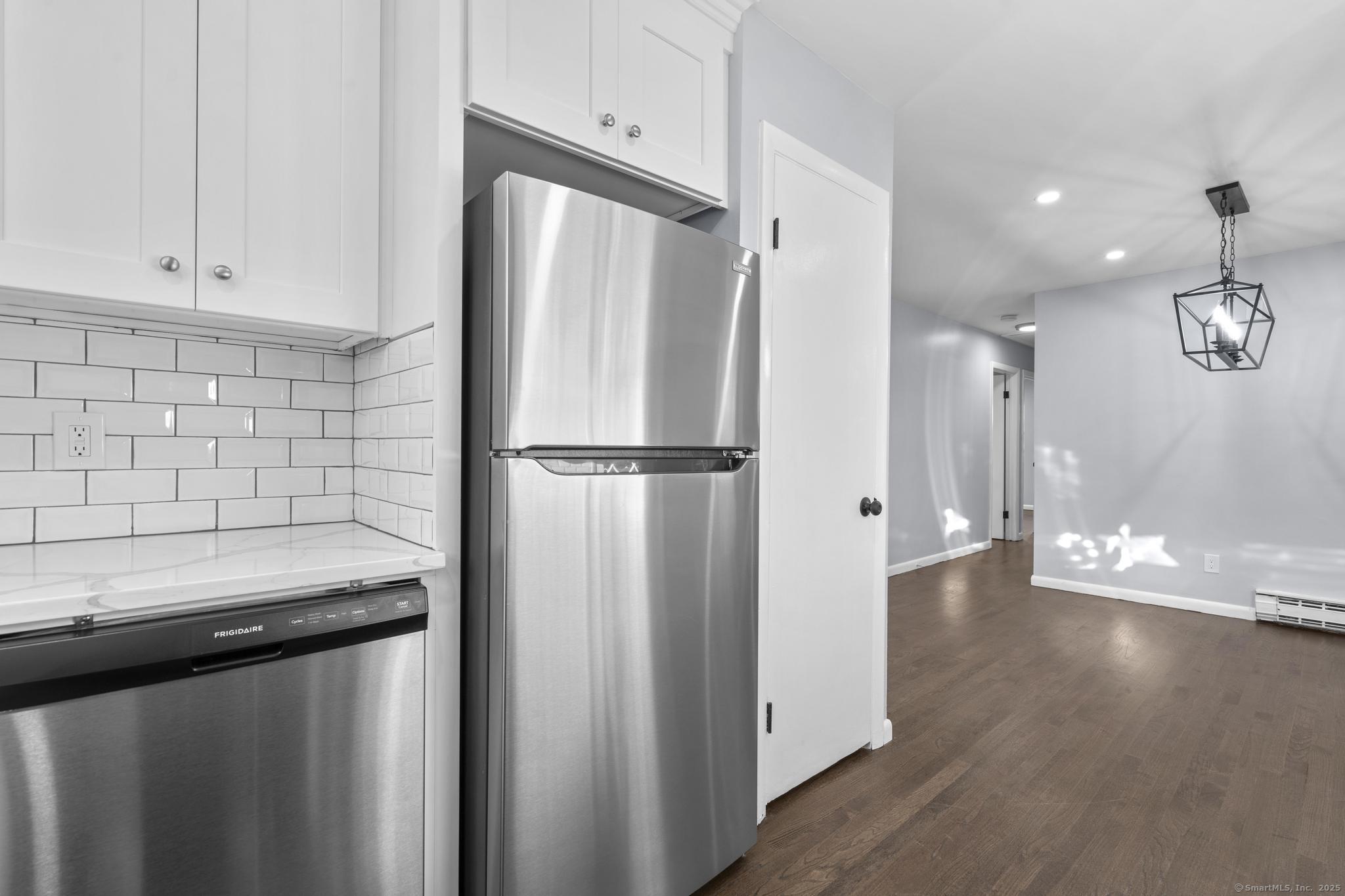 99 Roosevelt Avenue West Haven, CT 06516 - Photo 8 of 27 a view of a kitchen with a sink and wooden floor