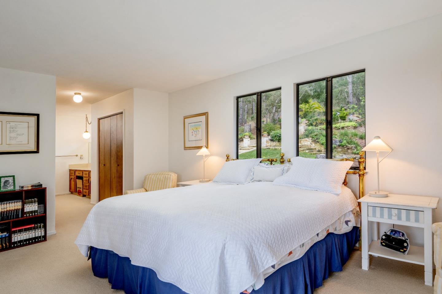 219 Peter Pan Road Carmel, CA 93923 - Photo 25 of 33 a bedroom with a large bed a flat tv screen and a dresser