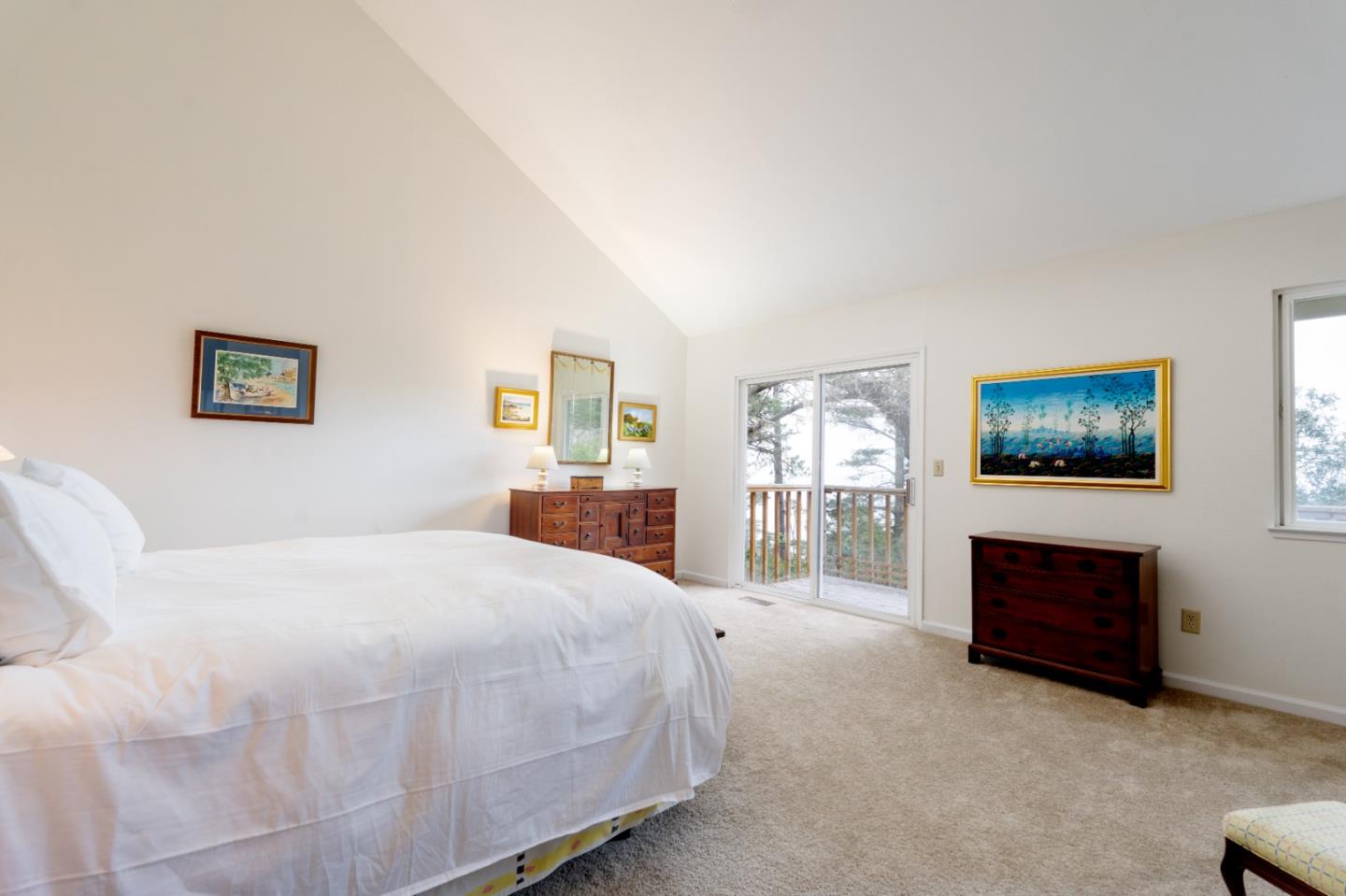 219 Peter Pan Road Carmel, CA 93923 - Photo 26 of 33 a spacious bedroom with a bed and a flat screen tv