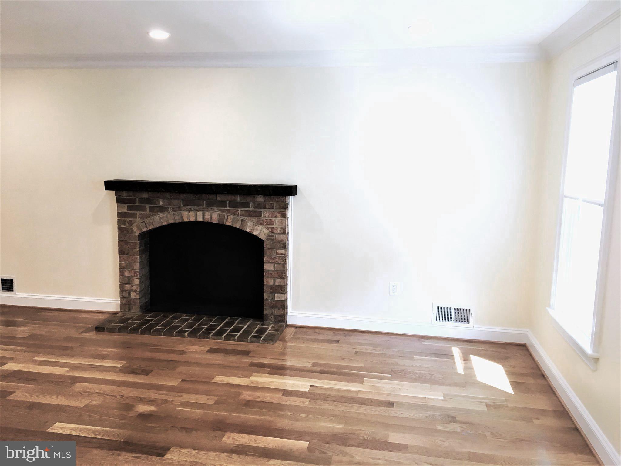 11514 Seven Locks Road Potomac, MD 20854 - Photo 26 of 72 a view of empty room with a fireplace and wooden floor