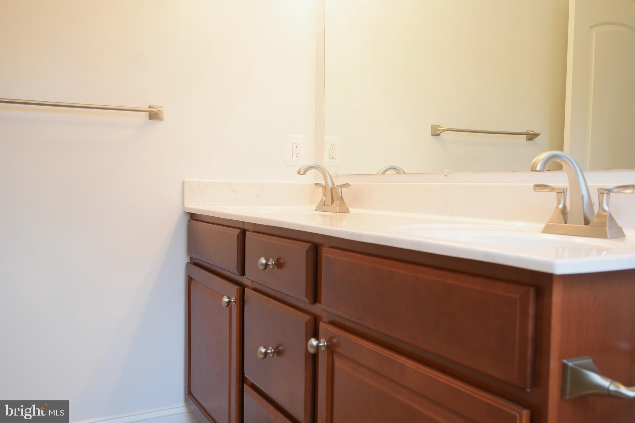 11514 Seven Locks Road Potomac, MD 20854 - Photo 34 of 72 a bathroom with a sink and a mirror