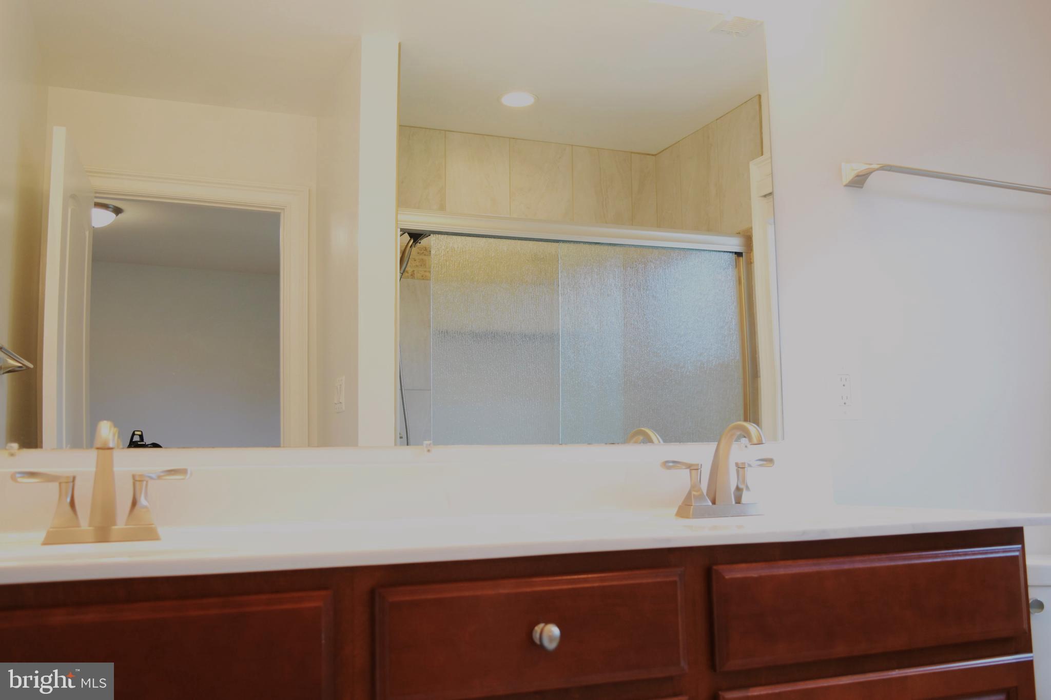 11514 Seven Locks Road Potomac, MD 20854 - Photo 35 of 72 a bathroom with a sink and a mirror