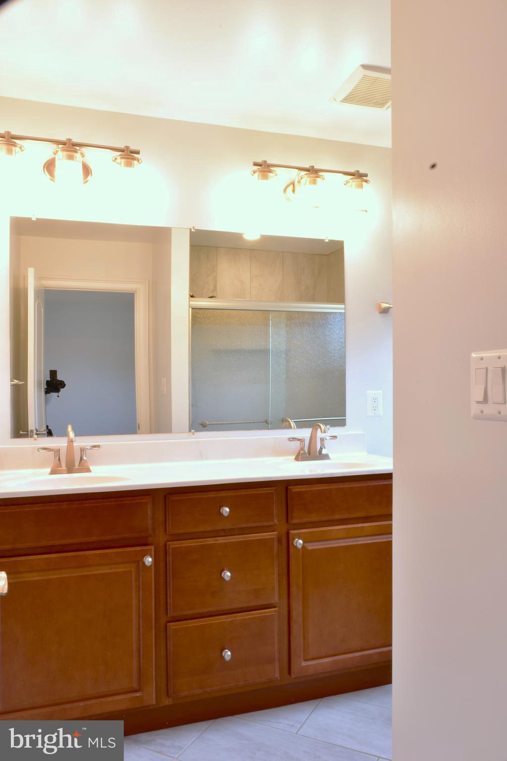 11514 Seven Locks Road Potomac, MD 20854 - Photo 36 of 72 a bathroom with a sink and a mirror