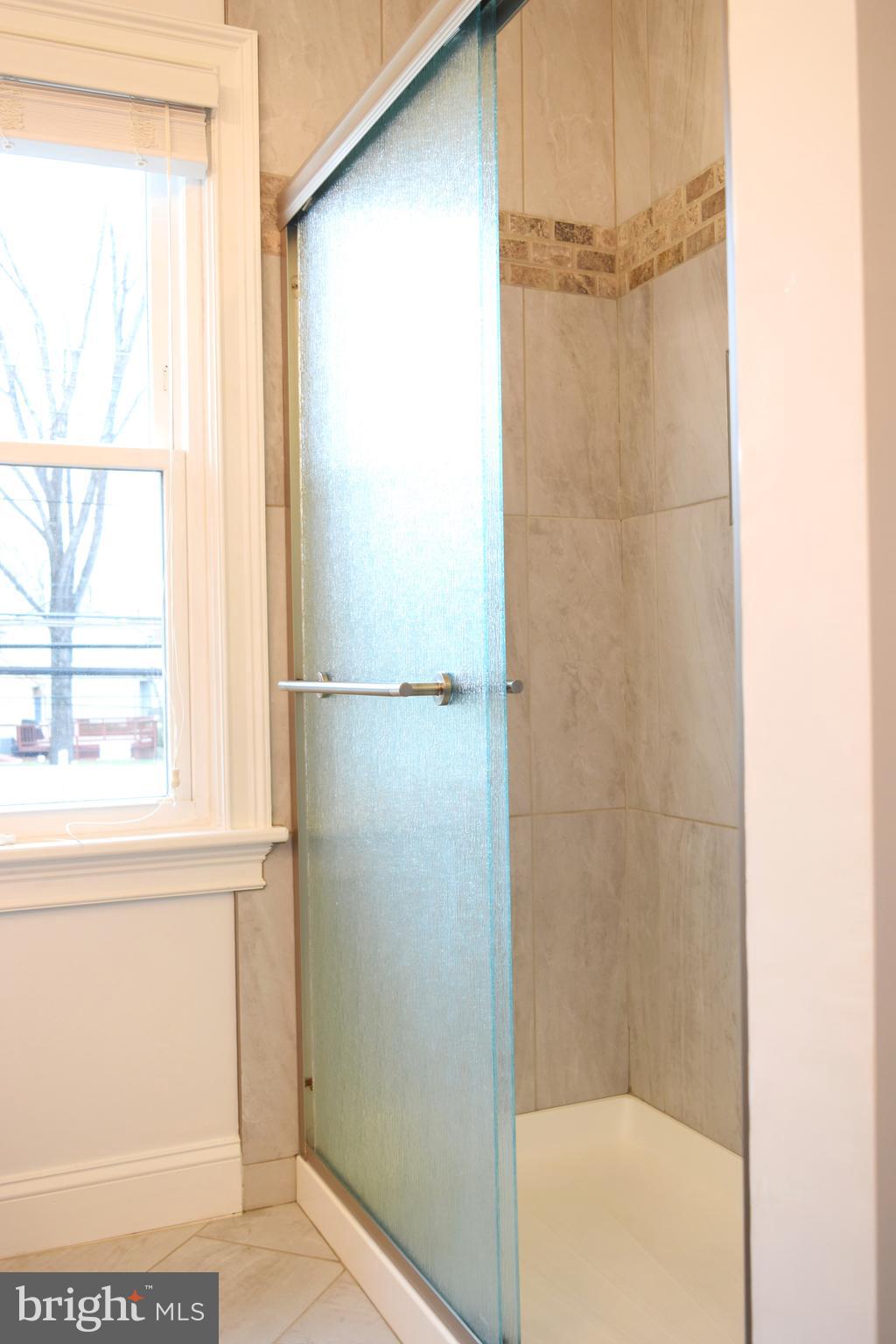 11514 Seven Locks Road Potomac, MD 20854 - Photo 38 of 72 a bathroom with a glass shower door