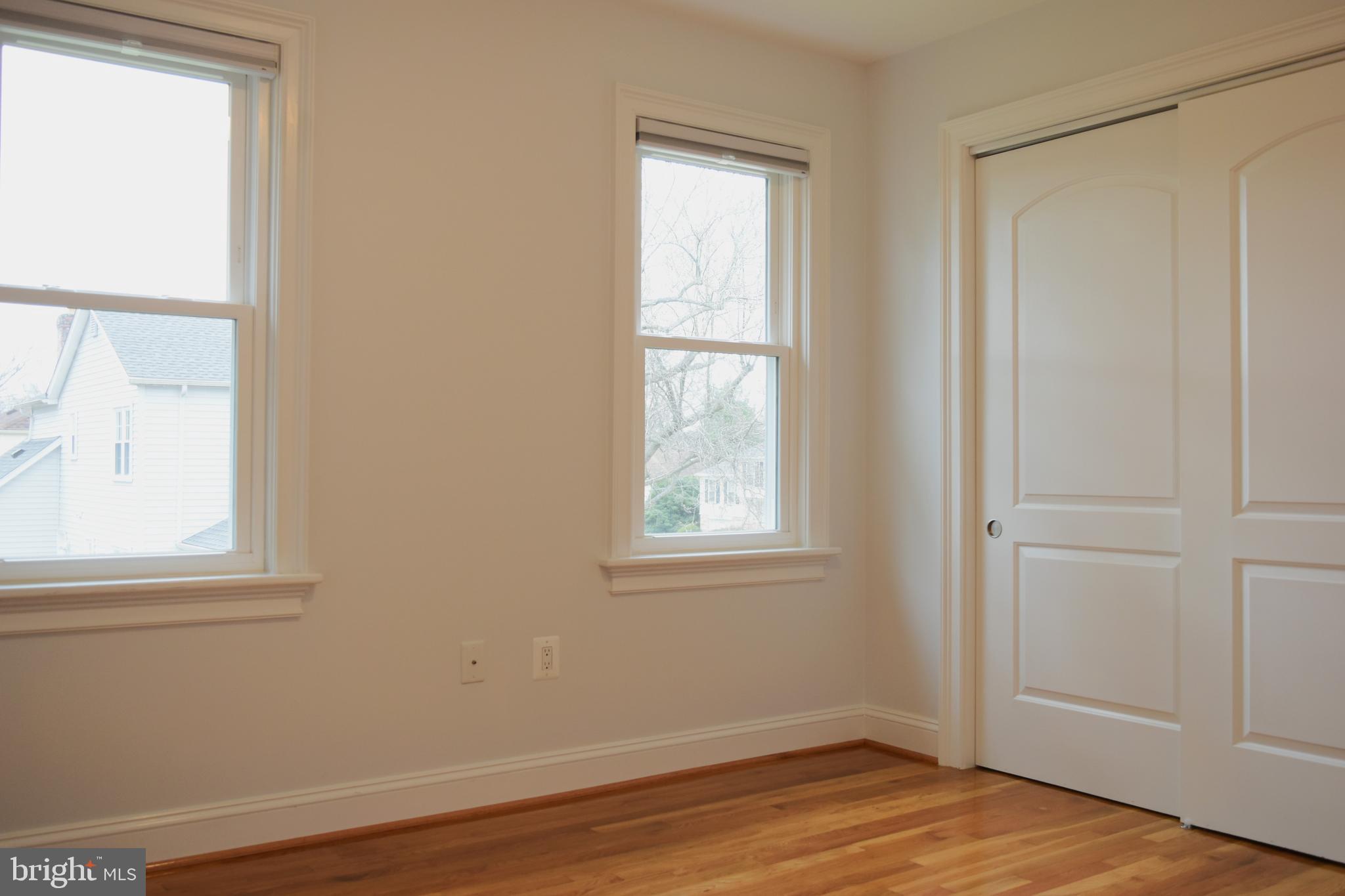 11514 Seven Locks Road Potomac, MD 20854 - Photo 40 of 72 an empty room with wooden floor and windows