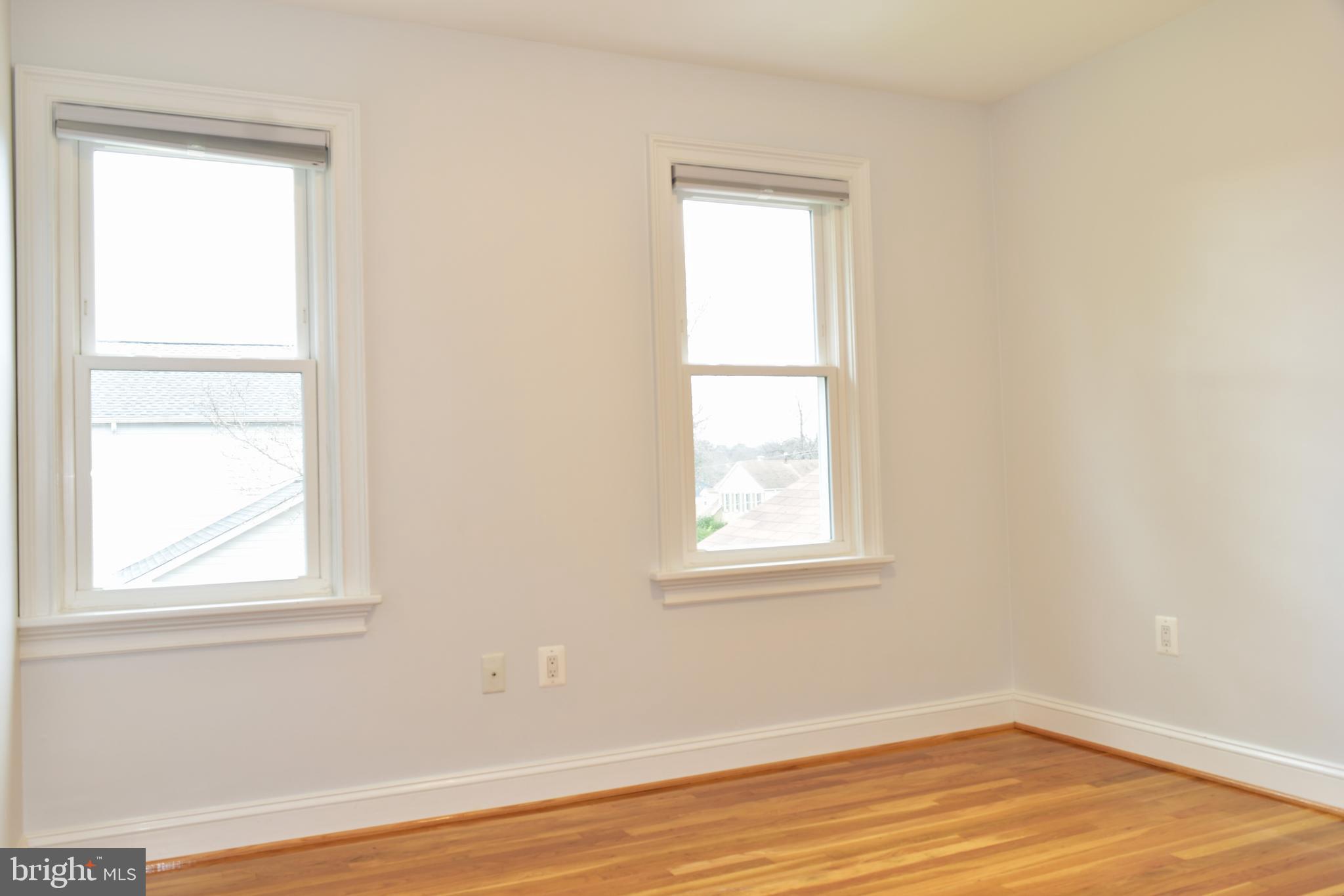 11514 Seven Locks Road Potomac, MD 20854 - Photo 42 of 72 an empty room with wooden floor and a window