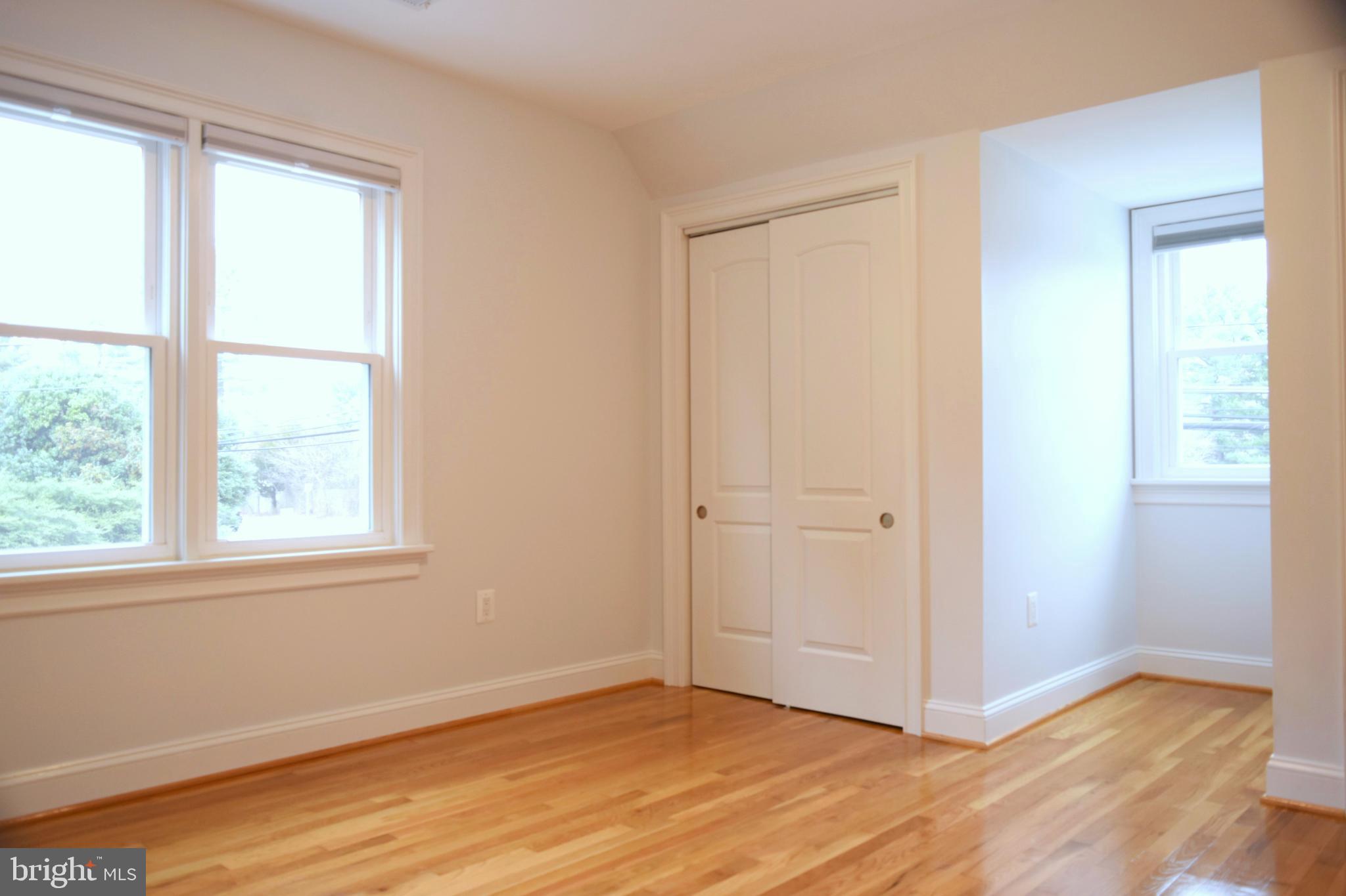 11514 Seven Locks Road Potomac, MD 20854 - Photo 44 of 72 a view of an empty room with wooden floor and a window
